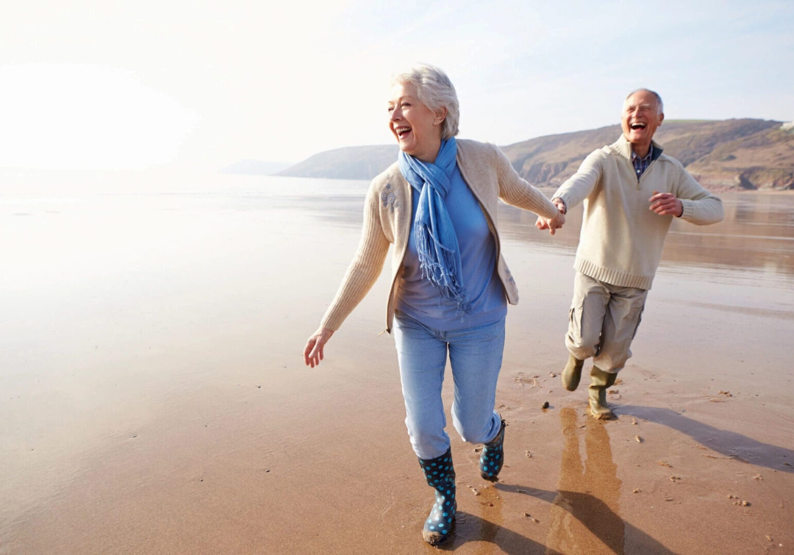 Two elderly people walking in the seaside